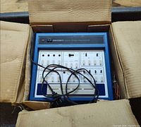 ET-3200 in open box with power cord and wires visible