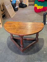 Top view of half-round oak table showing wood grain and wear