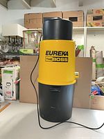 Front view of yellow and black Eureka The Boss central vacuum power unit