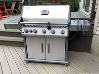 Front view of Napoleon stainless steel natural gas BBQ grill on casters