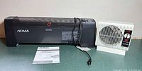 NOMA baseboard heater, Seabreeze heater and instruction manual on countertop
