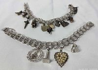 Overview of both sterling charm bracelets displaying chain styles and charms