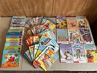 Tabletop view showing entire assortment of children’s paperback books arranged in three sections