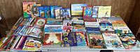 Overview of entire lot of children’s books spread on table