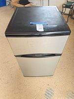 Front and top view of compact Frigidaire refrigerator showing stainless front and black top