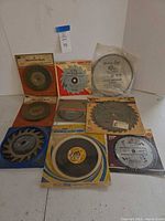 Group shot of nine packaged blades, brushes and wheels