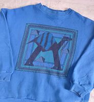 Front view of blue crewneck showing full geometric camel graphic