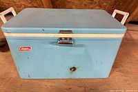 Front view showing Coleman logo, latch, rust spot
