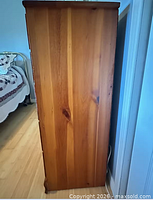 Right side of solid wood dresser showing wood grain and finish