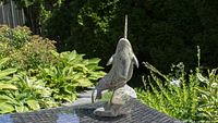 Front three-quarter view of soapstone narwhal carving on outdoor table