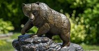 Front view of bronze grizzly bear on marble base