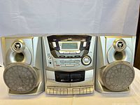 Front view of full stereo system showing main unit and speakers