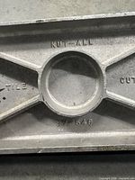 Kut-All brand cast marking on cutter base