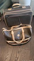 Suitcase and duffel front view showing matching pattern and trim