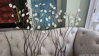 Full view of metal wall sculpture on sofa