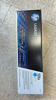 Front view of HP 131A cyan toner cartridge box