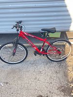 Left profile of red Huffy 24-inch mountain bike