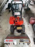 Front view of Craftsman 8/25 snowblower showing auger housing, chute, tire chains, and item tag