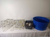 Group shot of jars, crate with lids/rings, and blue metal tub on table