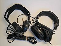 Two Yamaha HP-1 headphones with cables and adapter visible