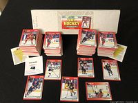 Overall view of both 328-card sets with box lid showing Score NHL Hockey branding and sample cards spread out