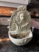 Front view of assembled lion head wall fountain operating