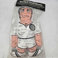 Front view of sealed voodoo doll in packaging