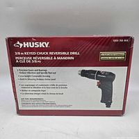 Front of sealed retail box showing brand, model, warranty, and image of drill