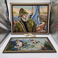 Both framed needlepoint pictures front view