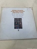 Front cover of Kenny Rogers & The First Edition Greatest Hits LP showing wear