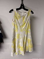 Front view of textured sleeveless dress on hanger