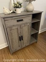 front view closed showing drawer, cabinet doors, open shelves
