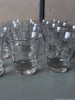 Front view showing multiple clear tumblers in rows