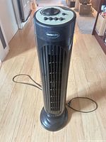 Front view of Homestyles black tower fan showing grille, base and power cord