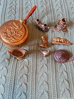 Group shot of all eight metal pieces on fabric background