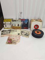 Group shot of all records showing picture sleeves, plain-sleeved stack and loose stack