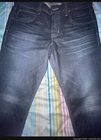 Front view of jeans showing color, style, and condition