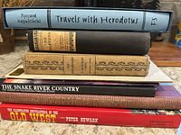Side view of stacked books showing spines and titles
