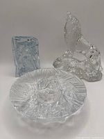 All three glass pieces grouped: candle holder foreground, wolf figurine right, polar bear sculpture left