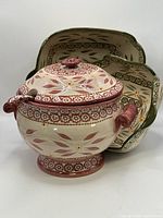 Soup tureen with lid and ladle, bowls nested behind