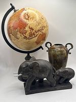 Group shot of globe, vase and elephant sculpture