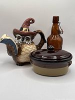 Group shot: owl pitcher, Grolsch bottle, covered casserole