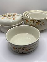 Group view of all six stoneware pieces including covered baking dish, nesting bowls and casserole