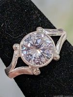 Front view of ring showing round CZ center stone and split shank
