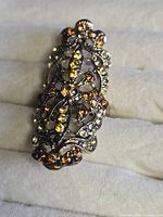 Front view of elongated rhinestone ring on display pad