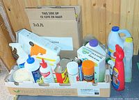 Overview of two boxes containing assorted cleaners and chemical products