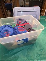 Plastic tote containing multiple baseball caps