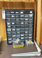Full view of blue 56-drawer organizer with hardware boxes and shelf brackets
