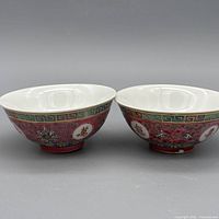 Two matching red famille rose longevity porcelain bowls side by side