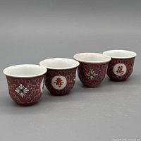 Group of four red famille-rose porcelain sake cups